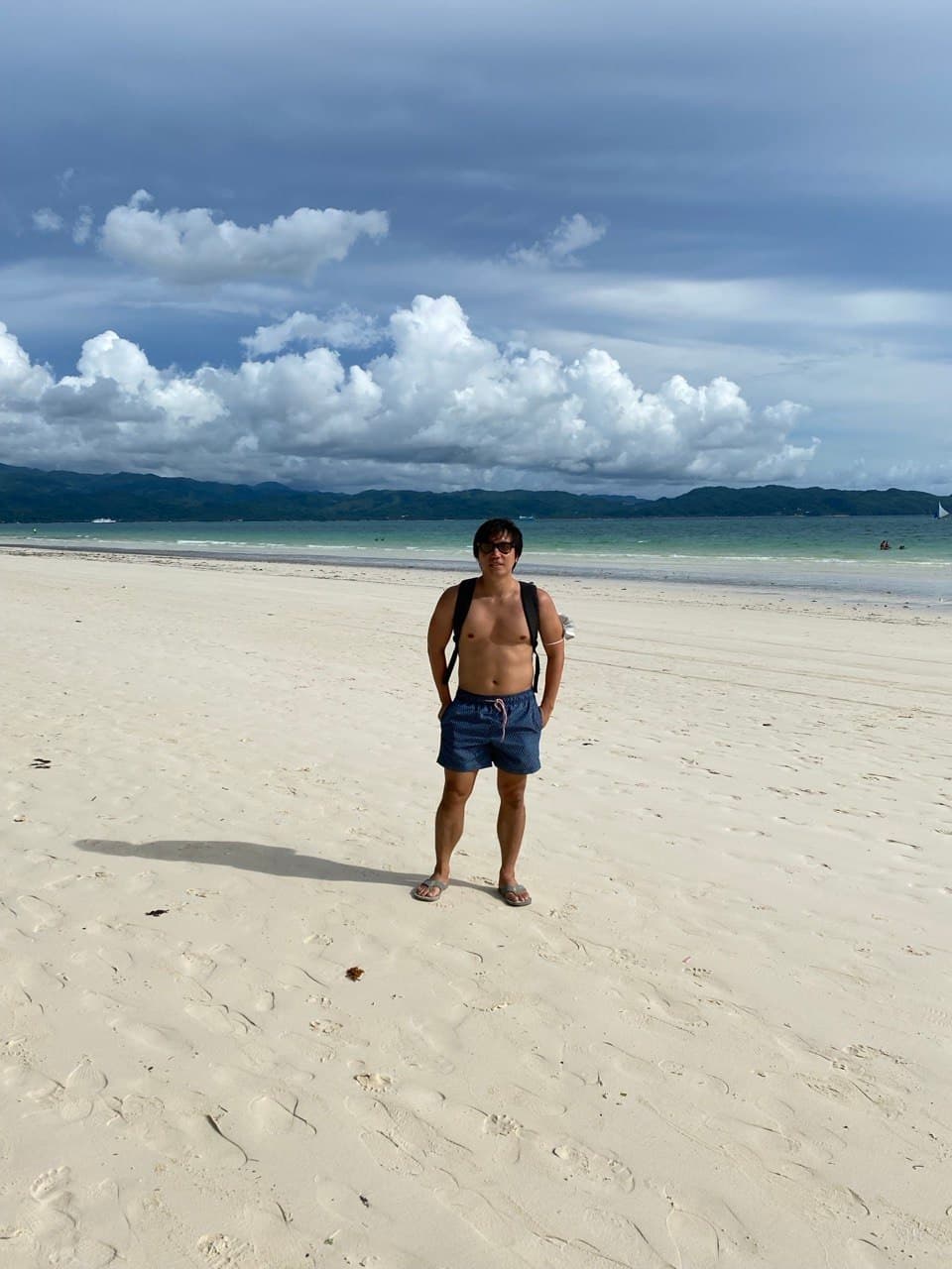 White Beach in Boracay during the 2021 pandemic, nearly empty stretch of powdery sand with calm turquoise water and no crowds