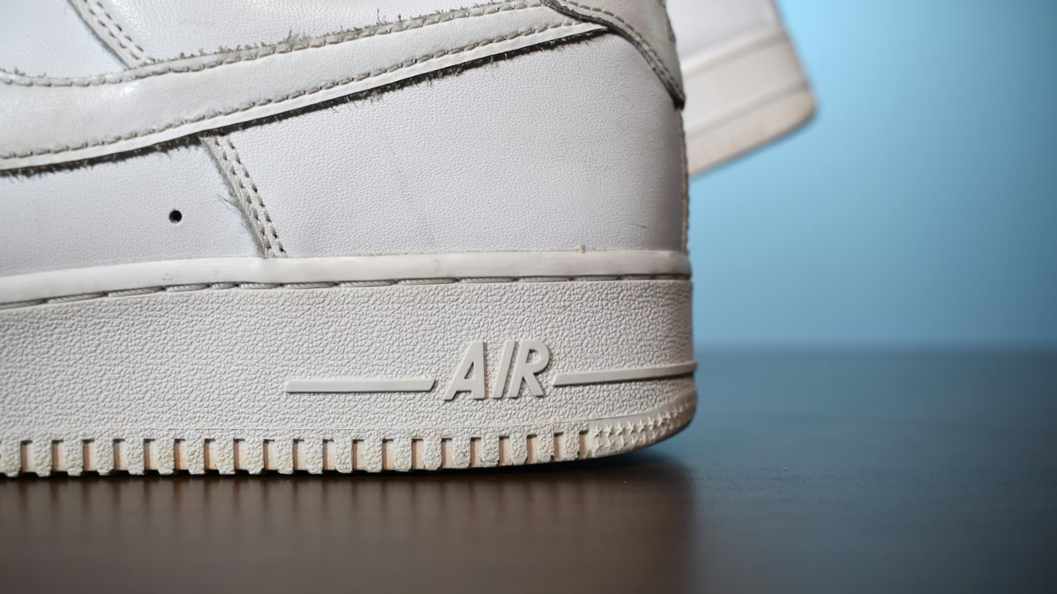 White sneakers after a DIY cleaning attempt at home โ uneven results, slight discoloration