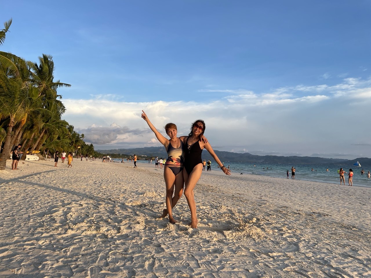 Golden sunset over Boracay's White Beach in 2021, with minimal people on the sand and warm light reflecting off the water